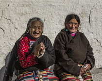 Two Khamba Tibetan women from the Kham region of eastern Tibet on a pilgrimage to visit holy sites in Lhasa, Tibet.  They are wearing their colorful traditional bangdian or pangden aprons.