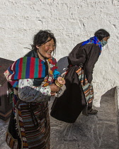 Two Khamba Tibetan women from the Kham region of eastern Tibet on a pilgrimage to visit holy sites in Lhasa, Tibet.  They are wearing their colorful traditional bangdian or pangden aprons.