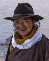 A young Khamba Tibetan woman from the Kham region of eastern Tibet on a pilgrimage to visit the Potala Palace in Lhasa, Tibet.  She has a white Buddhist prayer scarf or khata around her neck.  Felt co...