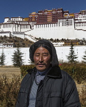 A Tibetan Buddhist pilgrim from the Kham region of eastern Tibet visits the Potala Palace in Lhasa, Tibet.