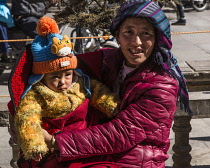 A Tibetan mother with her young child in Lhasa, Tibet.