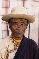 A Tibetan Buddhist pilgrim from the Kham region of eastern Tibet circumambulating around the Jokhang Temple in Lhasa, Tibet.