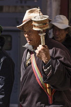 A Tibetan Buddhist pilgrim from the Kham region of eastern Tibet circumambulating around the Jokhang Temple in Lhasa, Tibet.