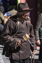 A Tibetan Buddhist pilgrim from the Kham region of eastern Tibet circumambulating around the Jokhang Temple in Lhasa, Tibet.