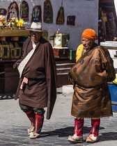 Tibetan Buddhist pilgrims from the Kham region of eastern Tibet circumambulating around the Jokhang Temple in Lhasa, Tibet.