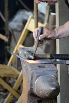 Industry, Traditional, Metalwork, Blacksmith working with hot metal on anvil.