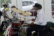 Music, Percussion, Drums, Drummer playing with band in a tent.