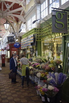 England, Oxford, Covered Market, buying flowers in the Covered Market.
