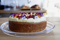 England, Oxford, Barefoot cafe, Jericho, fresh cake decorated with fruit and edible flowers.