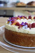 England, Oxford, Barefoot cafe, Jericho, fresh cake decorated with fruit and edible flowers.