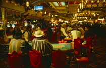 USA, Nevada, Las Vegas, Customers and croupiers at gambling tables in the Luxor Hotel.