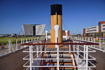 Ireland, County Antrim, Belfast, Titanic Quarter, Titanic Belfast visitor attraction seen from the upper deck of the restored SS Nomadic a former tender for the White Star Line shipping company  that...