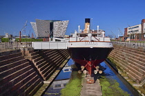 Ireland, County Antrim, Belfast, Titanic Quarter, Titanic Belfast visitor attraction with the SS Nomadic a former tender for the White Star Line shipping company  that was once used to transfer mail a...