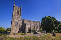 Ireland, County Down, Downpatrick, Cathedral Church of the Holy Trinity also known as Down Cathedral with Mourne granite slab marking the traditional burial place of St Patrick in the foreground.