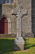 Ireland, County Down, Downpatrick, Replica of Downpatrick High Cross with the Cathedral Church of the Holy Trinity also known as Down Cathedral in the background.