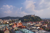 Slovenia, Ljubljana, Vista of the city towards Ljubljana Castle from the 12th floor viewing terrace of  the Neboticnik or Skyscraper Building.