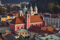 Slovenia, Ljubljana, Vista of the city from the 12th floor viewing terrace of  the Neboticnik or Skyscraper Building with the Franciscan Church of the Annunciation and the Cathedral of St Nicholas pro...