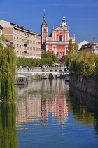 Slovenia, Ljubljana, Preseren Square, Facade of the Franciscan Church of the Annunciation reflected in the Ljubljanica River.