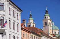 Slovenia, Ljubljana, Mestni trg streetscape with towers and dome of the Cathedral of St Nicholas in the background.