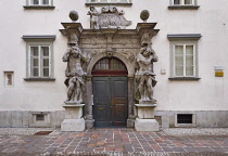 Slovenia, Ljubljana, Entrance to Ljubljana Theological Seminary Library with two sculptures of Atlas flanking the doorway.