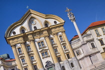 Slovenia, Ljubljana, Ursuline Church of the Holy Trinity in Kongresni Trg or Congress Square with the Holy Trinity Column on right.