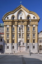 Slovenia, Ljubljana, Ursuline Church of the Holy Trinity in Kongresni Trg or Congress Square with the Holy Trinity Column in front.