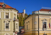 Slovenia, Ljubljana, The facade of the Philharmonic Hall in Kongresni Trg on right with Ljubljana Castle  high in the background.