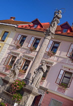 Slovenia, Upper Carniola, Skofja Loka, Mestni trg Square, Plague Column from 1751 with St Roch, Virgin Mary with infant Jesus  and St Anthony.