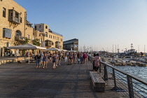 Israel, Jaffa, Old Jaffa, Tourists on the promenade along the seafront buildings at the Old Jaffa Port, Namal Yafo.