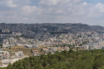 Israel, Galilee, Nazareth, Modern Nazareth built on the hillsides of Galilee in Israel. The Church of the Annunciaton is located at right center. On the skyline are the dome and minaret of a Muslim mo...