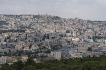 Israel, Galilee, Nazareth, Modern Nazareth built on the hillsides of Galilee in Israel. The Church of the Annunciaton is located at center. On the skyline are the dome and minaret of a Muslim mosque....