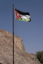 Jordan, Wadi Rum Protected Area, The flag of the Hashemite Kingdom of Jordan flying at the Visitors Center of the Wadi Rum Protected Area, a UNESCO World Heritage Site.