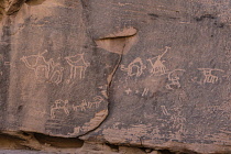 Jordan, Wadi Rum Protected Area, Ancient rock art depicting a camel caravan in Khaz'ali Canyon in the Wadi Rum Protected Area, a UNESCO World Heritage Site. The petroglyphs are of Thamudic origin and are more than 2000 years old. Also shown are some Arabian or Nubian ibex.