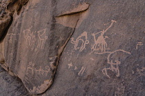 Jordan, Wadi Rum Protected Area, Ancient rock art depicting a camel caravan in Khaz'ali Canyon in the Wadi Rum Protected Area, a UNESCO World Heritage Site. The petroglyphs are of Thamudic origin and...