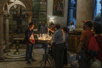 Israel, Jerusalem, Christian pilgrims visiting the Church of the Holy Sepulchre in the Christian Quarter. The Old City of Jerusalem and its Walls is a UNESCO World Heritage Site. This church was built...