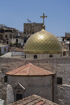Israel, Jerusalem, A rooftop view of the Christian Quarter in the Old City. In the foreground is the golden dome of the Greek Orthodox Church of Saint John the Baptist, with the Tower of Phasael in th...