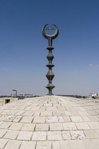 Israel, Jerusalem, The Muslim crescent on top of a small mosque in the Christian Quarter of the Old City. The Old City of Jerusalem and its Walls is a UNESCO World Heritage Site. On the horizon at lef...