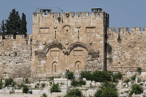 Israel, Jerusalem, Mount of Olives, The Eastern Gate, the Golden Gate or the Gate of Mercy of the Old City with the Temple Mount or al-Haram ash-Sharif behind it. In front is a Muslim cemetery. The Ol...