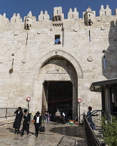 Israel, Jerusalem, Three Haredic or Ultra-Orthodox Jewish men by the Damascus Gate on the north side of the Old City. The Old City of Jerusalem and its Walls - UNESCO World Heritage Site.