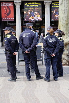 Spain, Catalonia, Barcelona, Male and Female Police officers.
