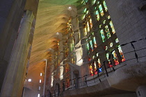 Spain, Catalonia, Barcelona, Interior of the Sagrada Familia designed by Antoni Gaudi, Nave, Passion side, Joan Vila-Grau designed stained glass .