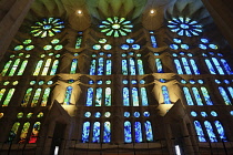 Spain, Catalonia, Barcelona, Interior of the Sagrada Familia designed by Antoni Gaudi, Nave, Passion side, Joan Vila-Grau designed stained glass .