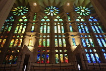 Spain, Catalonia, Barcelona, Interior of the Sagrada Familia designed by Antoni Gaudi, Nave, Passion side, Joan Vila-Grau designed stained glass .