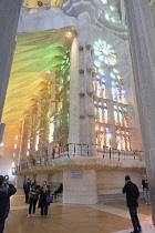 Spain, Catalonia, Barcelona, Interior of the Sagrada Familia designed by Antoni Gaudi, Nave, Passion side, Joan Vila-Grau designed stained glass .