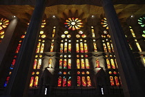 Spain, Catalonia, Barcelona, Interior of the Sagrada Familia designed by Antoni Gaudi, Nave, Passion side, Joan Vila-Grau designed stained glass.