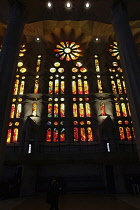 Spain, Catalonia, Barcelona, Interior of the Sagrada Familia designed by Antoni Gaudi, Nave, Passion side, Joan Vila-Grau designed stained glass.