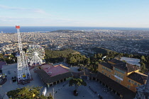 Spain, Catalonia, Barcelona, Mount Tibidabo Parc d'Attractions funfair and city view.