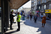 England, East Sussex, Brighton, People in queue with social distancing measures put in place by Waitrose supermarket to limit people entering the store.