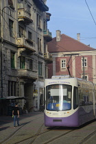 Romania, Timis, Timisoara, Modern tram passing Plata Libertatii, old town.