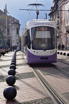 Romania, Timis, Timisoara, Modern tram passing Plata Libertatii, old town.